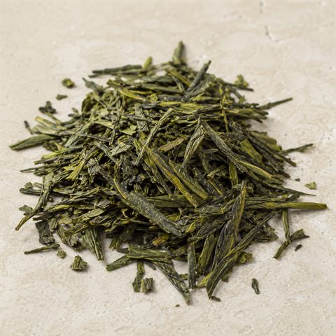 Dried green tea leaves, rolled and dark green